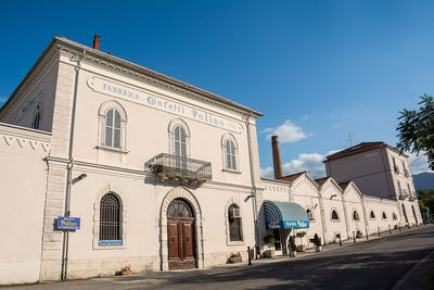 Exterior of buildings against blue sky in city