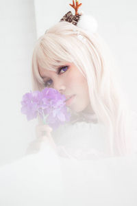 Portrait of beautiful woman against white background