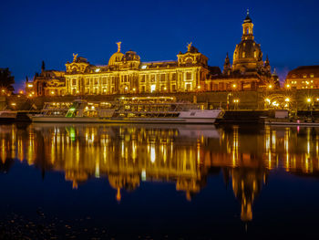 Reflection of illuminated buildings in water at night