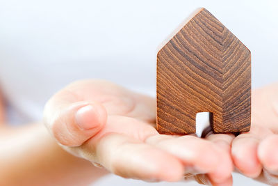 Midsection of woman holding wooden house block