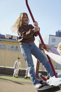 Girl swinging on playground swing