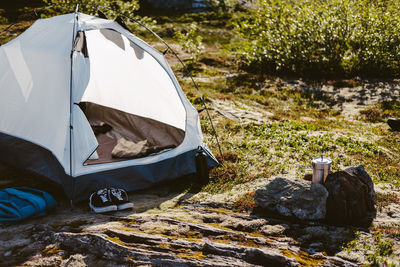 High angle view of tent on field by lake