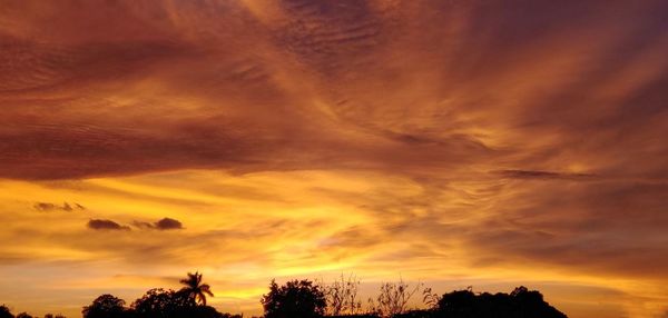 Low angle view of dramatic sky during sunset