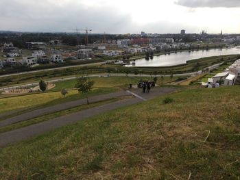 High angle view of river by city against sky