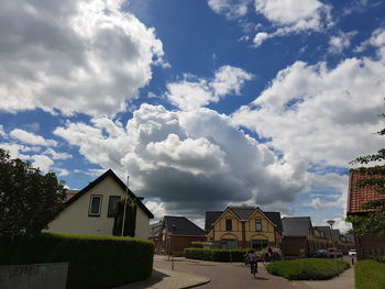 Buildings against cloudy sky