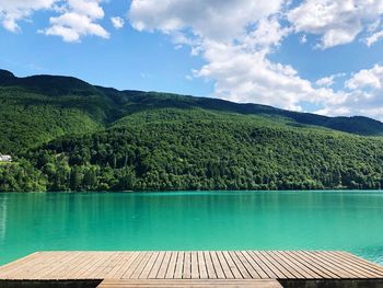 Scenic view of swimming pool by lake against sky