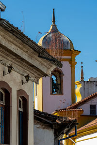 Low angle view of old building against clear blue sky