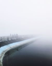 Scenic view of lake against sky during winter