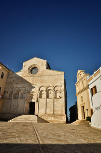 Low angle view of historic building against clear blue sky