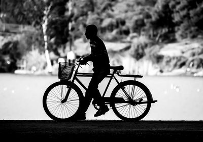 Side view of man with bicycle