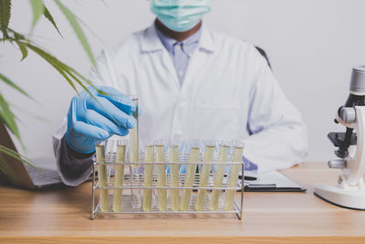 Midsection of scientist working in laboratory