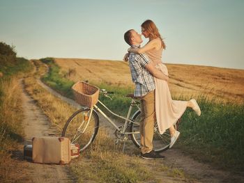 Couple embracing on dirt road