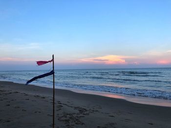Scenic view of beach against sky during sunset