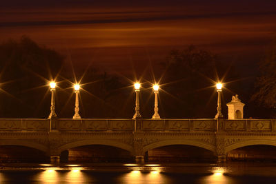 Illuminated bridge at night