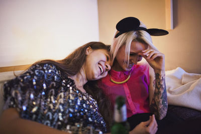 Two friend laughing at a party