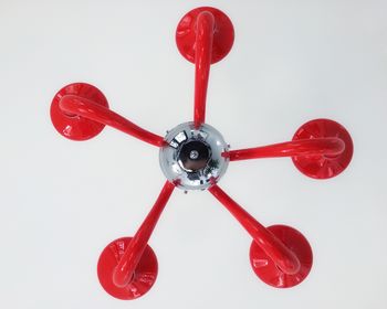 Close-up of red object over white background