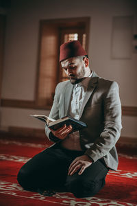 Young man using mobile phone at home