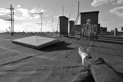 A man is lying on an old roof in berlin