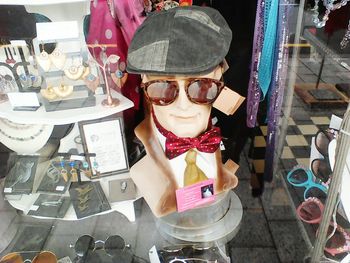 Young woman wearing sunglasses standing in store