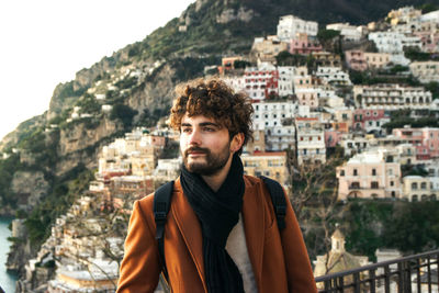 Portrait of young man looking at city