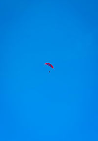 Low angle view of man paragliding