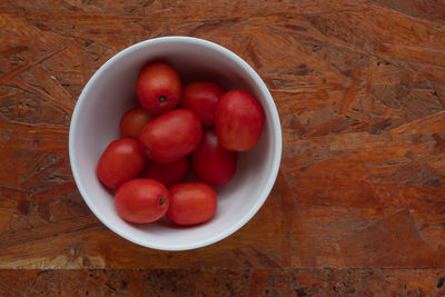 High angle view of strawberries in bowl on table