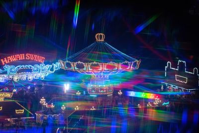 Illuminated ferris wheel at night