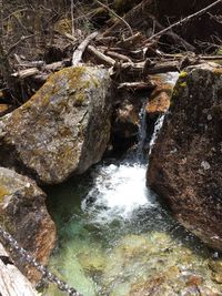 High angle view of waterfall amidst rocks