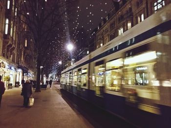 Illuminated city street at night