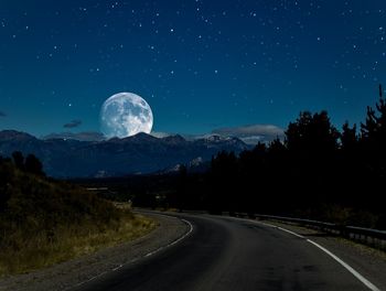 Scenic view of mountains against sky at night