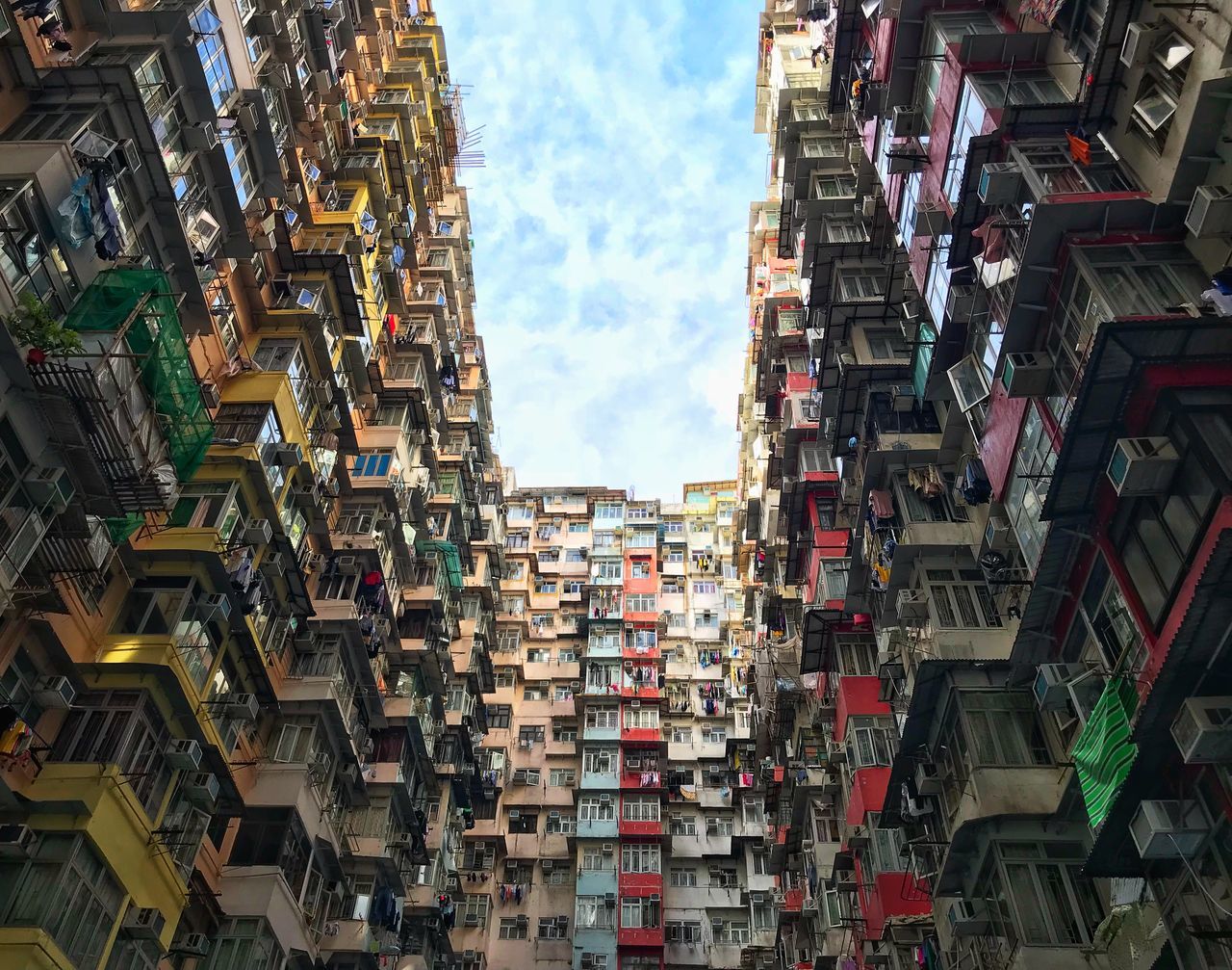 architecture, building exterior, built structure, residential district, building, cloud - sky, sky, city, no people, day, low angle view, nature, outdoors, apartment, window, hanging, multi colored, community, abundance