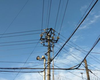 Low angle view of telephone line against sky