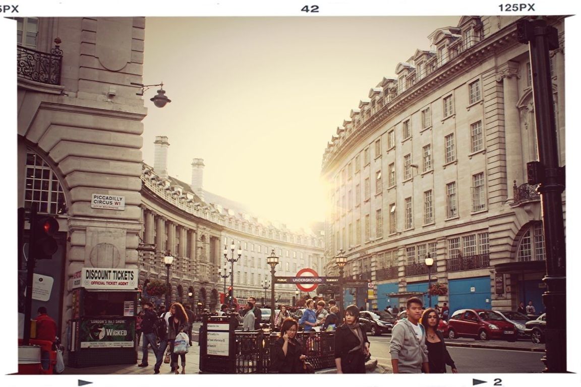 transfer print, building exterior, architecture, built structure, large group of people, auto post production filter, men, person, lifestyles, city, leisure activity, city life, mixed age range, street, medium group of people, walking, day, group of people, clear sky