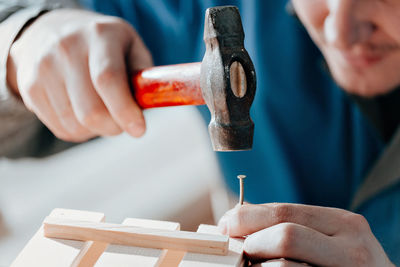 Cropped hands of man working in workshop