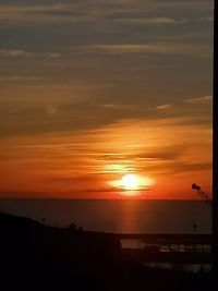 Scenic view of sea against orange sky