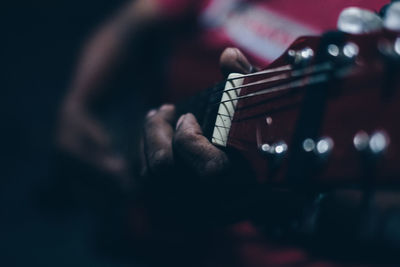 Close-up of man playing guitar