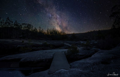 Scenic view of landscape against sky at night