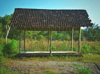 Old abandoned building on field against clear sky