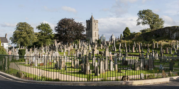 Panoramic view of trees and buildings against sky