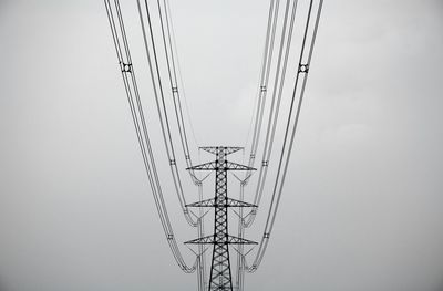 Low angle view of electricity pylon against sky