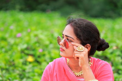 Close-up portrait of a serious young woman outdoors