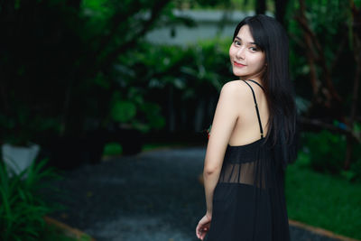 Portrait of smiling young woman standing outdoors