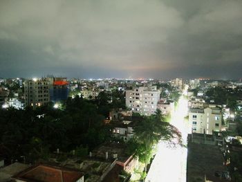 Aerial view of buildings in city against sky