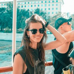 Portrait of smiling young woman wearing sunglasses