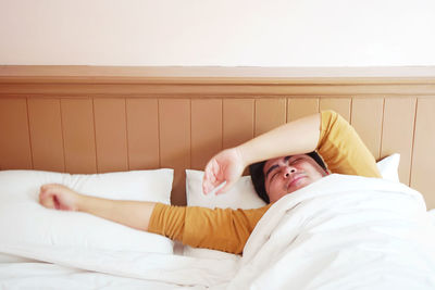 Young woman lying on bed