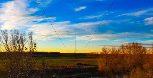 Scenic view of field against sky during sunset