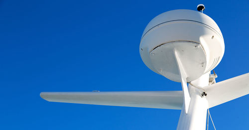 Low angle view of airplane against clear blue sky