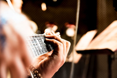 Cropped hands of man playing guitar