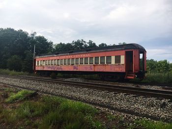 Train on railroad track against sky