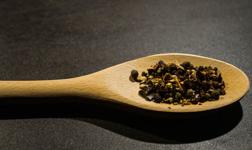 Close-up of spice in wooden spoon on table